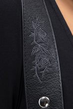Load image into Gallery viewer, Black leather strap with embossed design and silver button on a black background