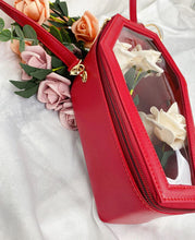 Load image into Gallery viewer, Red vegan leather coffin shaped bag with see through front. Inside of bag has black cross detail. Bag has full zip closure around entirety of coffin shape. Bag has adjustable shoulder strap.