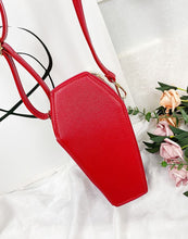 Load image into Gallery viewer, Red vegan leather coffin shaped bag with see through front. Inside of bag has black cross detail. Bag has full zip closure around entirety of coffin shape. Bag has adjustable shoulder strap.