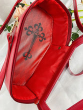 Load image into Gallery viewer, inside of red vegan leather coffin shaped bag with see through front. Inside of bag has black cross detail. Bag has full zip closure around entirety of coffin shape. Bag has adjustable shoulder strap.