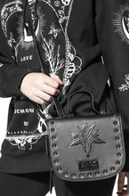 Load image into Gallery viewer, Black vegan leather backpack and crossbody bag. Features embossed bcc baphomet goat head on front with stud detail along front edges. Full zipper closure. Can be worn as a backpack, crossbody bag or can be carried with attached handle.
